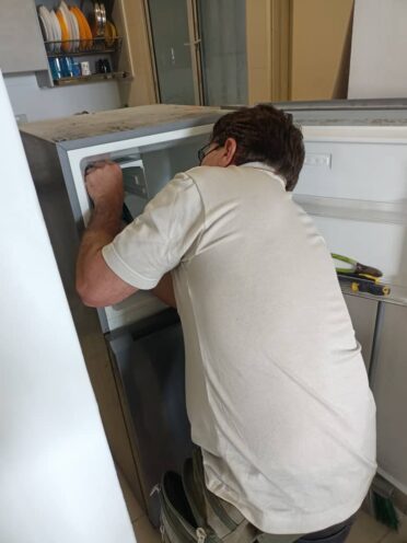 Refrigerator Repair 17 Technician repairing refrigerator, we offering professional fridge repair services